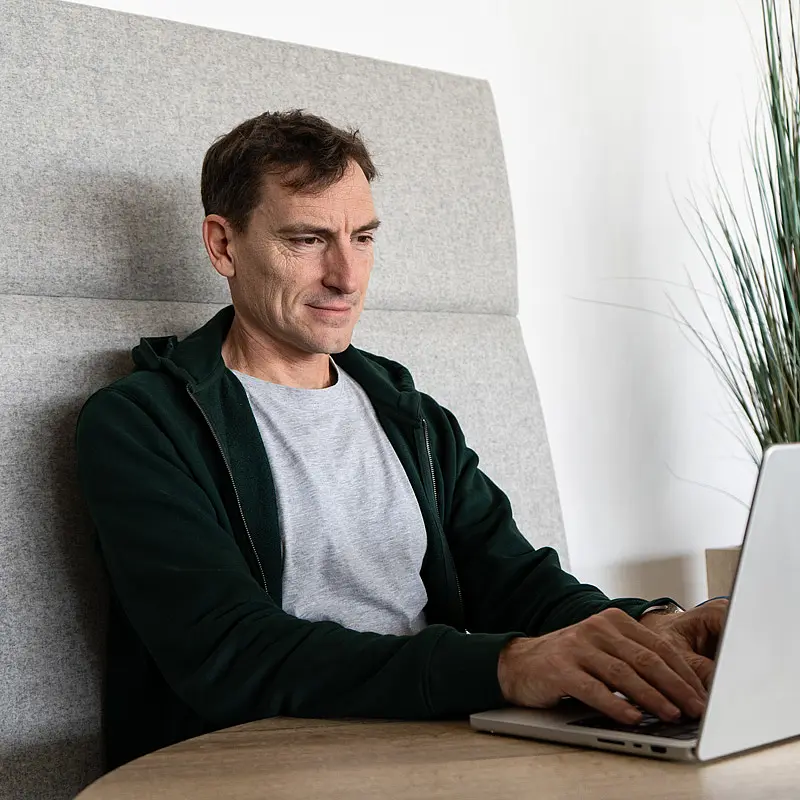 Ein Mitarbeiter am Laptop zur Entwicklung des Design Assistenten von CUORE